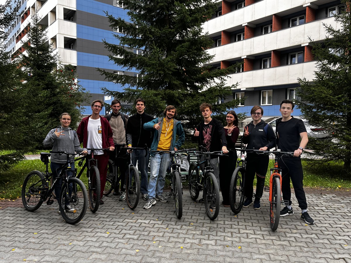Nine riders with their bicycles before the start